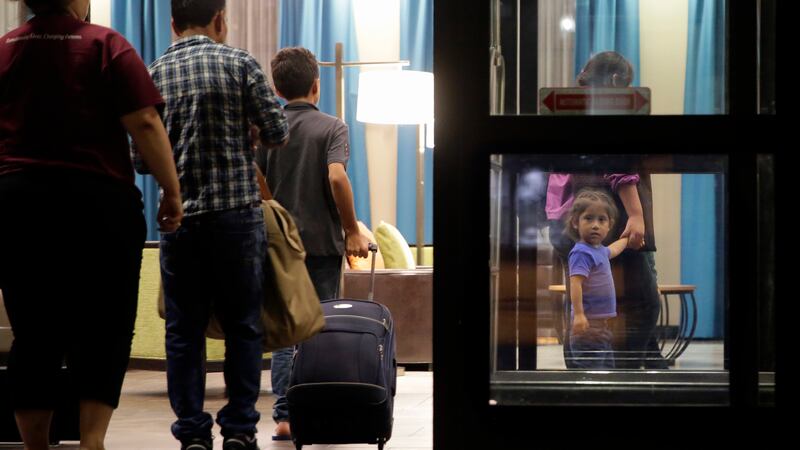 Immigrants seeking asylum who were recently reunited arrive at a hotel in San Antonio, July...