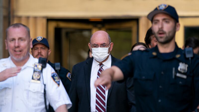 FILE - Law enforcement personnel escort the Trump Organization's former Chief Financial...